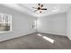 Carpeted bedroom features natural light from two windows and neutral paint at 3490 Buffington Ln, Cumming, GA 30040