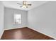 Cozy bedroom with hardwood floors, natural light, and neutral decor at 3490 Buffington Ln, Cumming, GA 30040