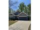 Charming one-story home with a well-manicured lawn, two car garage, and landscaped front yard at 3490 Buffington Ln, Cumming, GA 30040