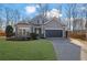 Charming single-Gathering home with a well-manicured lawn and a two-car garage in a residential neighborhood at 3490 Buffington Ln, Cumming, GA 30040