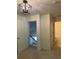 Upper-level hallway with a modern light fixture and doorway views to other rooms at 3490 Buffington Ln, Cumming, GA 30040