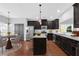 Stylish kitchen with dark cabinets, stainless steel appliances, and a granite countertop island at 3490 Buffington Ln, Cumming, GA 30040