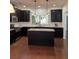 A gourmet kitchen features dark cabinetry, an island, and stainless steel appliances at 3490 Buffington Ln, Cumming, GA 30040