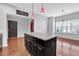 Kitchen island with granite countertop, cabinets, and wood flooring at 3490 Buffington Ln, Cumming, GA 30040