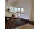 View of a staircase leading to the living room with large windows and hardwood floors at 3490 Buffington Ln, Cumming, GA 30040