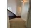 Carpeted staircase leading to an upper floor with a wall sconce at 3490 Buffington Ln, Cumming, GA 30040