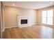Bright living room featuring new laminate flooring and a cozy white brick fireplace at 724 Redland Dr, Jonesboro, GA 30238