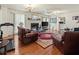 Living room with hardwood floors, fireplace, and leather couches at 1480 Niskey Lake Sw Rd, Atlanta, GA 30331