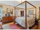 Spacious bedroom with four-poster bed and hardwood floors at 1480 Niskey Lake Sw Rd, Atlanta, GA 30331