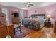 Main bedroom with a king-size bed and pink walls at 1480 Niskey Lake Sw Rd, Atlanta, GA 30331