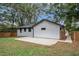 Modern home with white exterior, new concrete patio, and fenced backyard at 1934 Pinedale Pl, Decatur, GA 30032