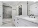 Bathroom featuring double sinks, white cabinets, and a luxurious marble shower at 1934 Pinedale Pl, Decatur, GA 30032