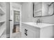 Clean bathroom with white vanity, black hardware, and open shelving at 1934 Pinedale Pl, Decatur, GA 30032