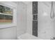 Bathroom with bathtub, white tile, and black mosaic accent at 1934 Pinedale Pl, Decatur, GA 30032