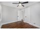 Bedroom with hardwood floors, fan and door opening to hall at 1934 Pinedale Pl, Decatur, GA 30032