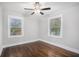 Spacious bedroom with hardwood floors, ceiling fan, and two windows at 1934 Pinedale Pl, Decatur, GA 30032