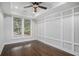 Bright bedroom features hardwood floors, wainscoting, and trey ceiling with recessed lighting at 1934 Pinedale Pl, Decatur, GA 30032