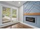 Close-up of a modern fireplace with a geometric feature wall and hardwood floors at 1934 Pinedale Pl, Decatur, GA 30032