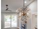 A view of modern chandelier lighting in living room with feature wall and hardwood floors at 1934 Pinedale Pl, Decatur, GA 30032