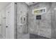 Walk-in shower featuring gray marble tile, black hardware, and glass enclosure at 1934 Pinedale Pl, Decatur, GA 30032