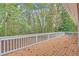 Outdoor deck with white railing overlooking a lush, wooded backyard at 369 Antioch Rd, Dallas, GA 30157