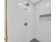 Modern shower with marble tile and gold fixtures at 369 Antioch Rd, Dallas, GA 30157