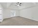 Spacious bedroom with carpet, ceiling fan, and doors leading to a deck at 369 Antioch Rd, Dallas, GA 30157