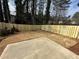 Fenced backyard with a concrete patio and newly mulched landscaping, creating a private outdoor space at 799 River Gardens Se Dr, Atlanta, GA 30354