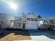 Two-story home with beige siding, a covered porch and two-car garage at 799 River Gardens Se Dr, Atlanta, GA 30354