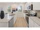 Modern kitchen with white cabinets, granite countertops, and stainless steel appliances at 799 River Gardens Se Dr, Atlanta, GA 30354