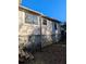 Side view of house showing a concrete foundation and wooden steps at 2145 Marbut Farns Ct, Lithonia, GA 30058