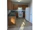 Galley kitchen with wood cabinets and new flooring at 2331 Rambling Way, Lithonia, GA 30058