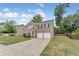 Two-story brick home with a two-car garage and grassy yard at 3178 Cedar Crest Way, Decatur, GA 30034