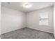 Simple bedroom with grey carpet and a single window at 4839 Dufour Dr, Lilburn, GA 30047