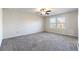 Large bedroom with grey carpeting and ceiling fan at 4839 Dufour Dr, Lilburn, GA 30047