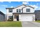 Two-story house with white siding, gray shutters, and a two-car garage at 4839 Dufour Dr, Lilburn, GA 30047