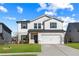 Two-story house with white siding, gray shutters, and a two-car garage at 4839 Dufour Dr, Lilburn, GA 30047