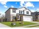 Two-story house with white siding, gray shutters, and a two-car garage at 4839 Dufour Dr, Lilburn, GA 30047