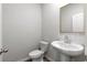 Small powder room with pedestal sink and white subway tile at 4839 Dufour Dr, Lilburn, GA 30047