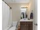 Clean bathroom with dark vanity and shower/tub combo at 5514 Park S Pl, Atlanta, GA 30349