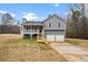 Gray house with white trim, two-car garage, and a deck at 23 Faith Ct, Douglasville, GA 30134