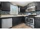 Kitchen features dark cabinets and stainless steel appliances at 23 Faith Ct, Douglasville, GA 30134