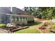 Well-maintained backyard with white picket fence, patio seating area, and beautiful landscaping at 2509 Fairweather Ct, Conyers, GA 30013