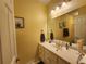 Well-lit bathroom featuring a vanity with sink, a large mirror, and classic fixtures at 2509 Fairweather Ct, Conyers, GA 30013