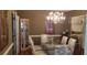 Elegant dining room features a chandelier, glass table, and mirrored display cases at 2509 Fairweather Ct, Conyers, GA 30013