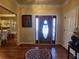 Inviting foyer features a decorative front door, hardwood floors, and elegant lighting at 2509 Fairweather Ct, Conyers, GA 30013