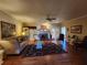 Cozy living room features a fireplace, ceiling fan, hardwood floors and elegant furniture at 2509 Fairweather Ct, Conyers, GA 30013