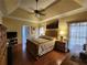 Elegant main bedroom with hardwood floors, a tray ceiling, and ample natural light at 2509 Fairweather Ct, Conyers, GA 30013