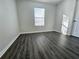 Spacious bedroom featuring wood-look floors and a window at 6450 Arbor Gate Sw Dr # 1, Mableton, GA 30126