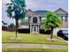 Brick two-story house with palm trees and a large yard at 160 Oak Manor Dr, Covington, GA 30016